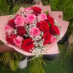 A bouquet of pink and red and fillers